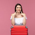 Young woman smiling with dental treatment tools in Albania dental clinic.